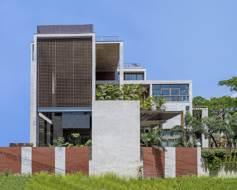 Concrete and brick residence with a timber lattice facade and rooftop gardens